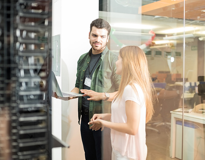 Man and woman talking near IT department